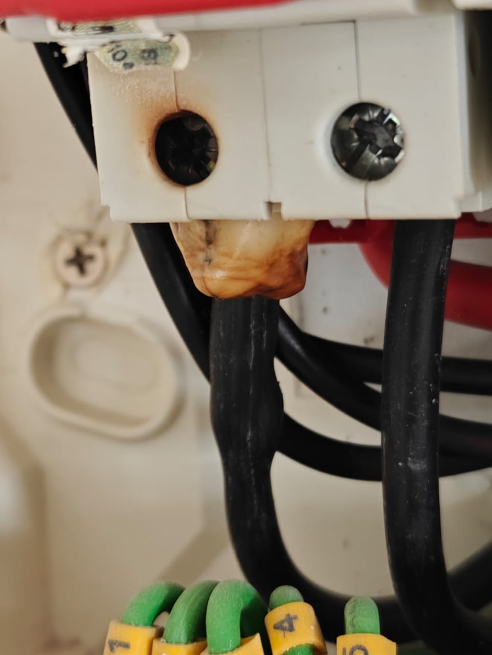 Melted main circuit breaker component inside a distribution board